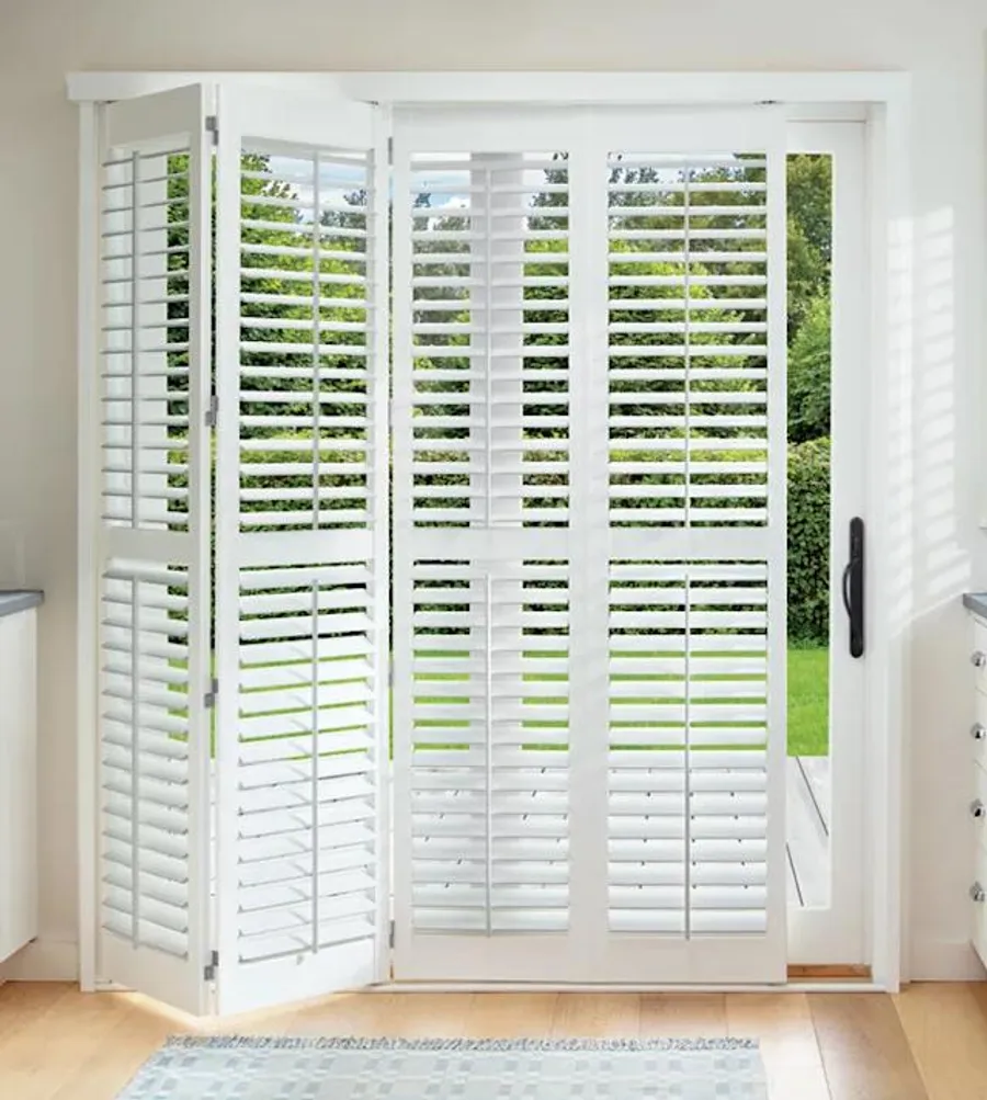Plantation shutters on large glass door with hinges and track system