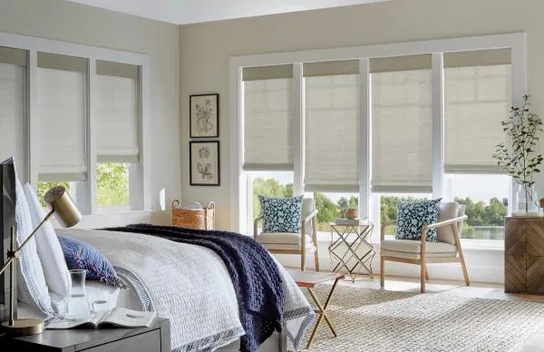 Natural woven shades with valances in bedroom
