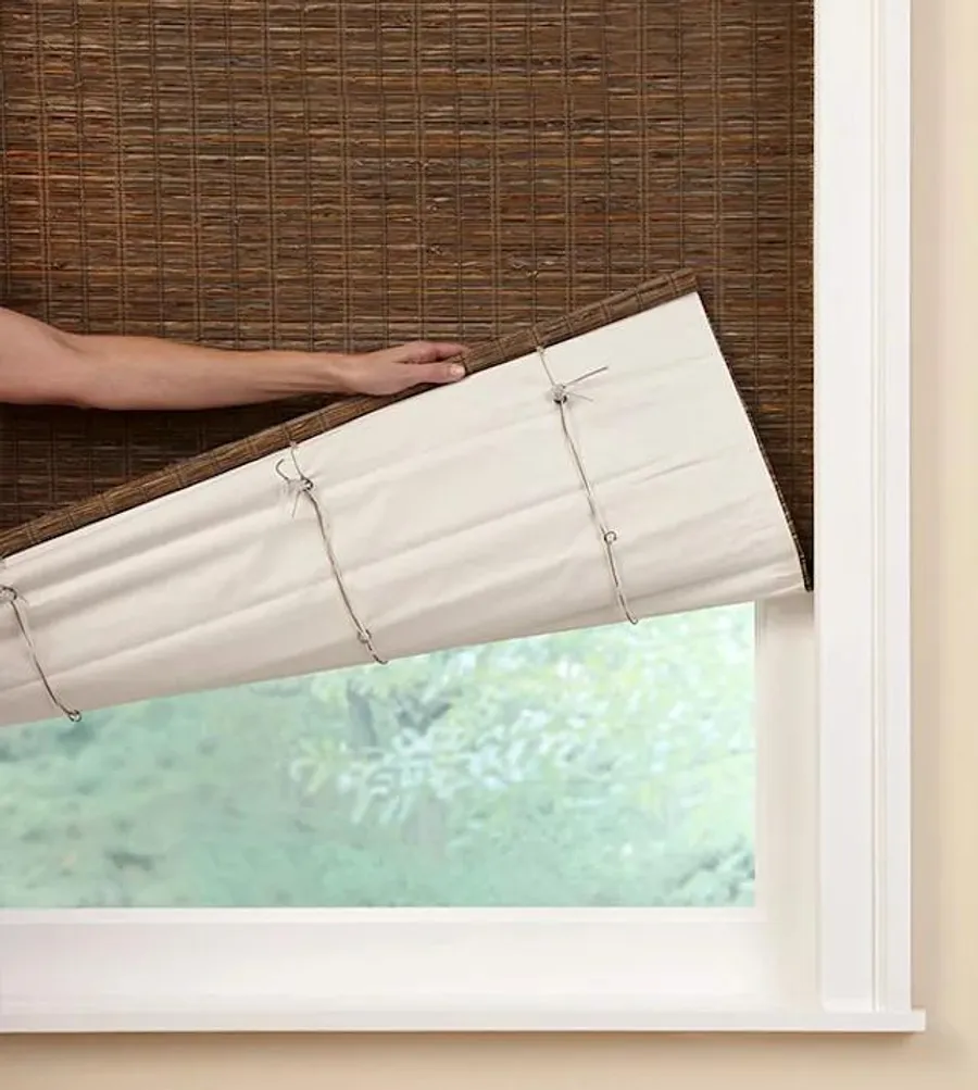 Natural woven shades with fabric backing layer